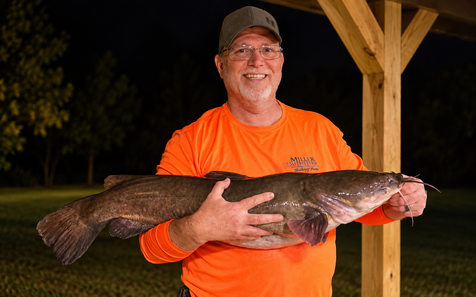 Keith from Miller Outfitters holding a large catfish